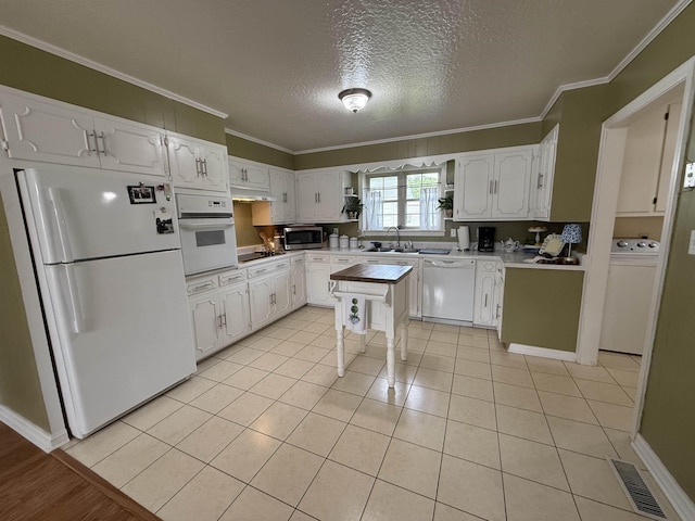  - kitchen with white appliances, a sink, washer / clothes dryer, white cabinets, and a textured ceiling