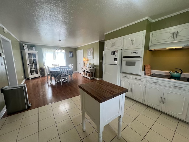  - kitchen with white appliances, wooden counters, crown molding, white cabinetry, and a chandelier