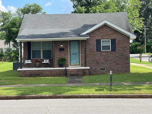  - view of front of house featuring brick siding, a front lawn, and a porch