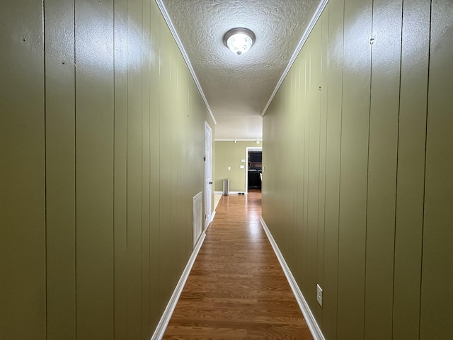  - hallway with dark wood-style floors and a textured ceiling