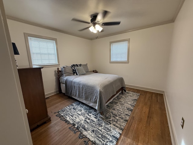  - bedroom with crown molding, dark wood-style flooring, baseboards, and ceiling fan