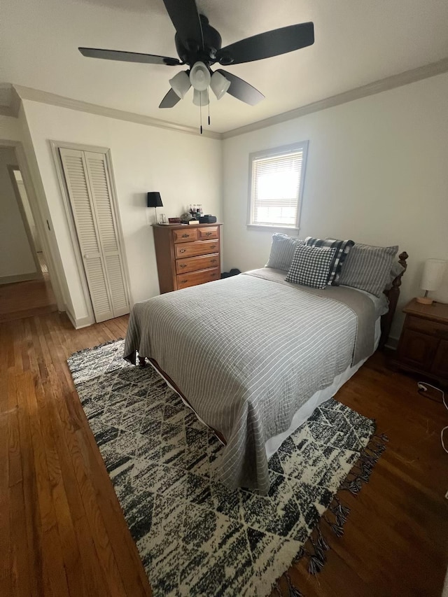  - bedroom featuring light wood-style flooring, a closet, ornamental molding, ceiling fan, and baseboards