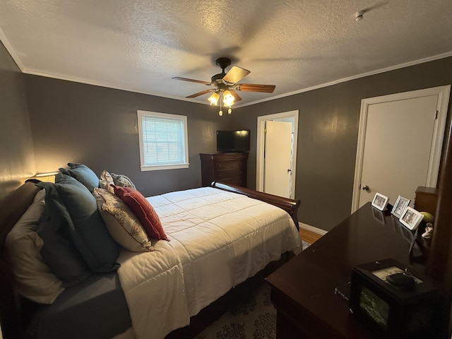  - bedroom featuring a textured ceiling, crown molding, a ceiling fan, baseboards, and wood finished floors