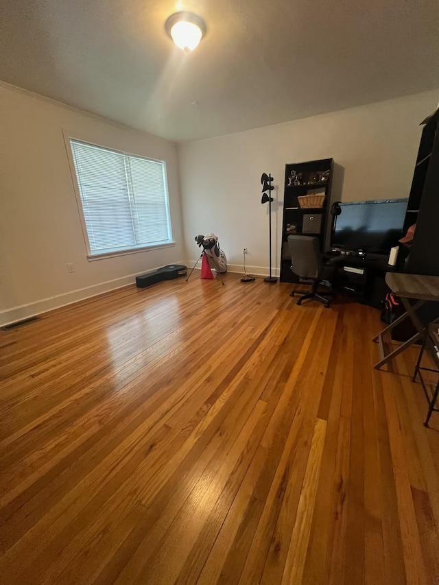  - home office with hardwood / wood-style floors and baseboards