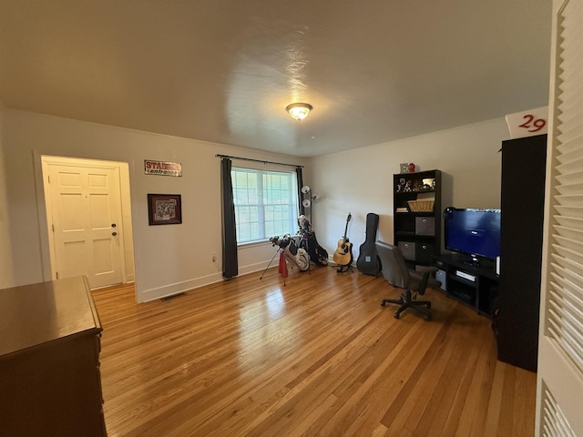  - office area with light wood-type flooring and baseboards