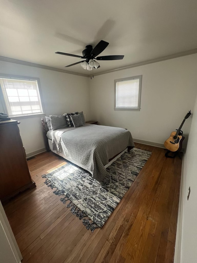  - bedroom with crown molding, hardwood / wood-style flooring, baseboards, and ceiling fan