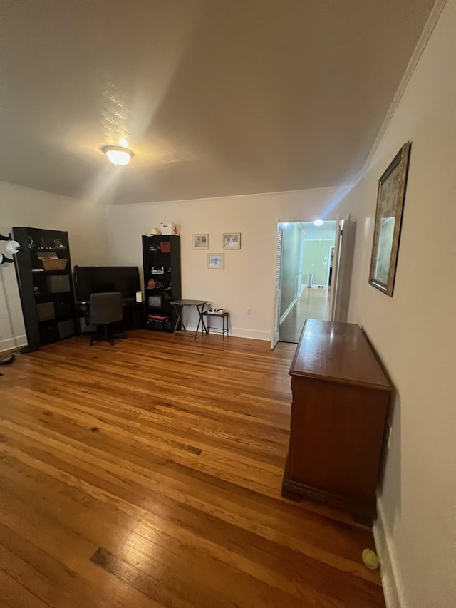  - living area featuring wood finished floors and baseboards