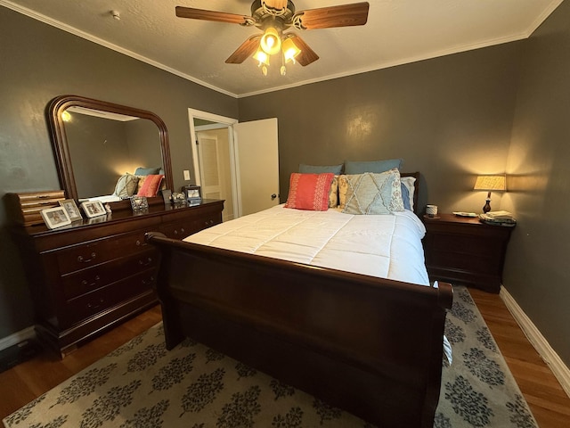  - bedroom with dark wood finished floors, baseboards, a ceiling fan, and ornamental molding