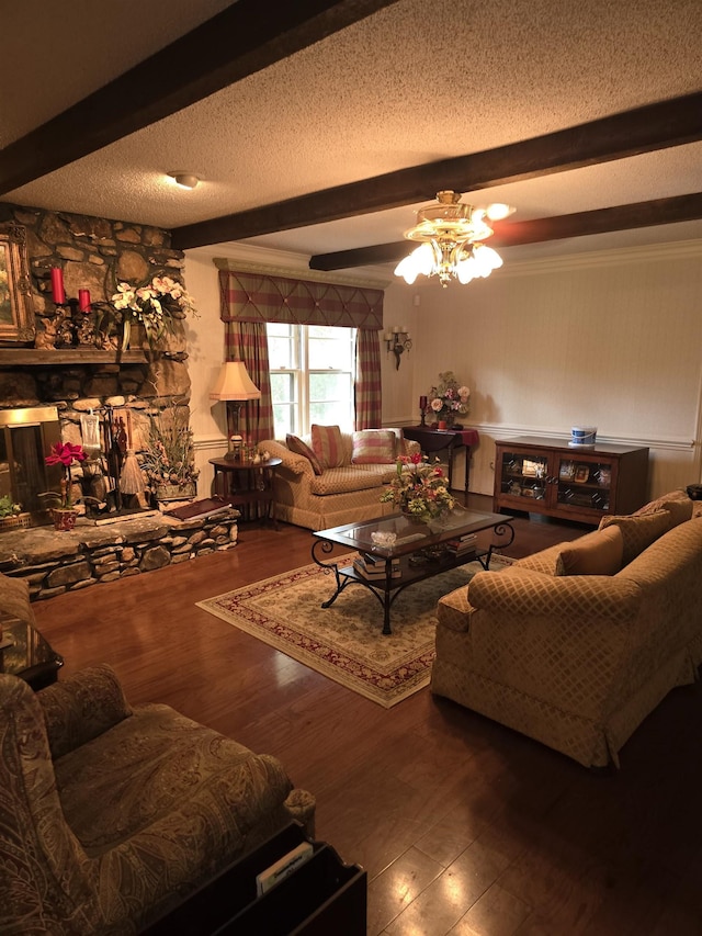 living room with a fireplace, a textured ceiling, wood-type flooring, and beamed ceiling