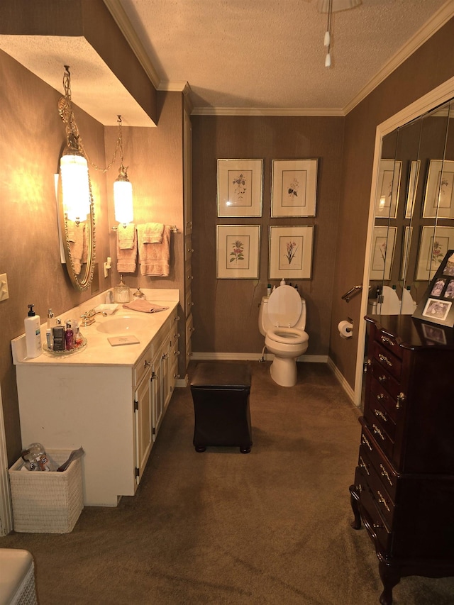 bathroom featuring ornamental molding, toilet, a textured ceiling, and vanity