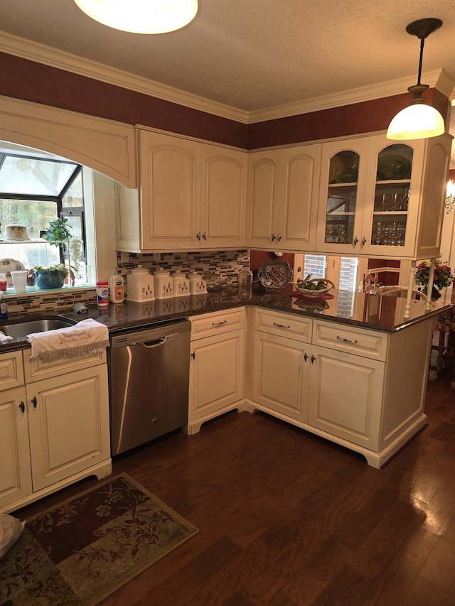 kitchen featuring white cabinets, dishwasher, hanging light fixtures, and dark wood-type flooring