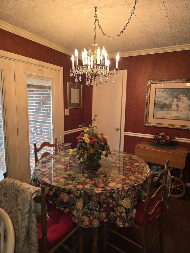 dining space with ornamental molding and an inviting chandelier