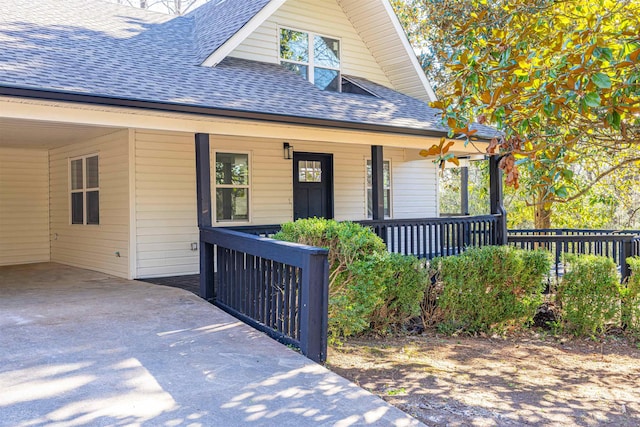 doorway to property featuring covered porch and a carport