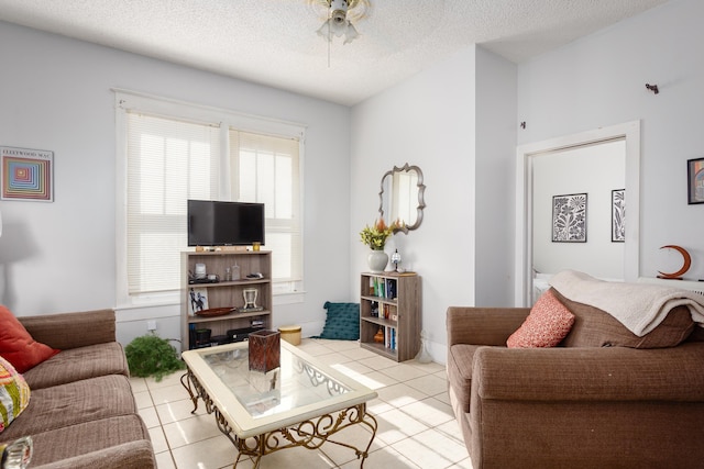  - living area featuring tile patterned flooring, ceiling fan, and a textured ceiling