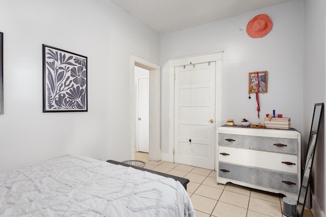  - bedroom with light tile patterned floors