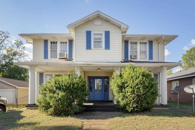  - view of front of house featuring covered porch, a front yard, and cooling unit