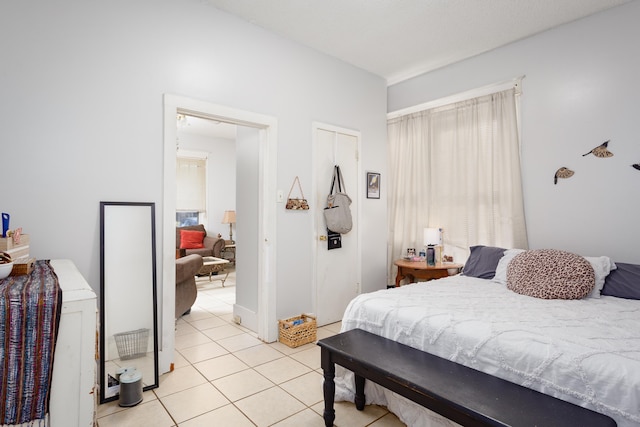  - bedroom featuring light tile patterned flooring and multiple windows