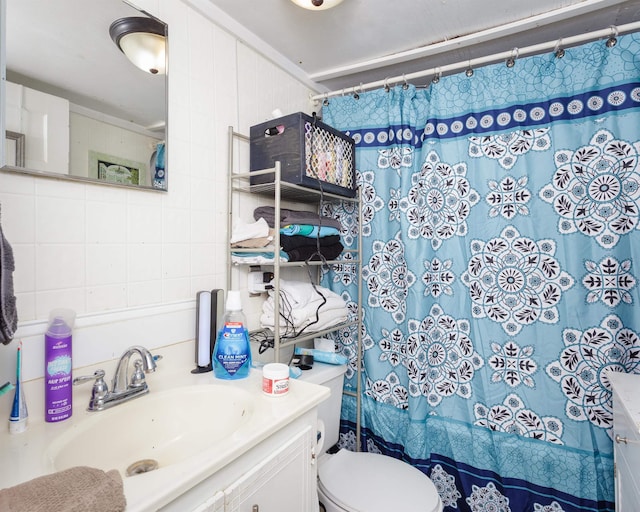  - bathroom featuring vanity, curtained shower, and tile walls