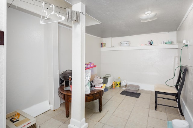  - interior space featuring tile patterned floors and a textured ceiling