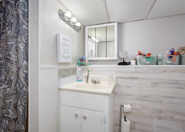  - bathroom with vanity and a textured wall