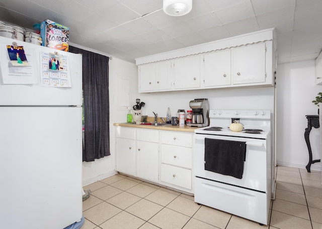  - kitchen with white appliances, light tile patterned flooring, and white cabinets