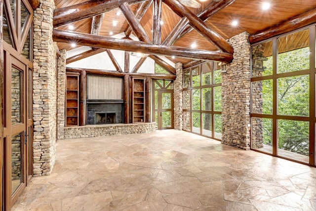 unfurnished living room featuring beam ceiling and wood ceiling