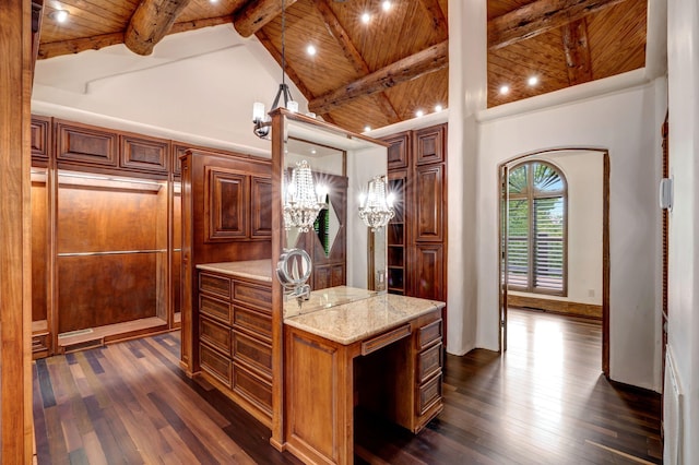 kitchen featuring wooden ceiling, beamed ceiling, dark wood-style flooring, and brown cabinets