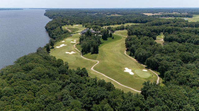 birds eye view of property featuring view of golf course, a view of trees, and a water view