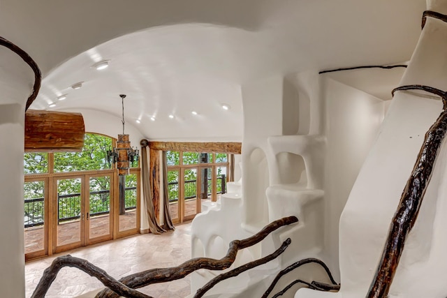 interior space featuring recessed lighting, french doors, marble finish floor, and vaulted ceiling