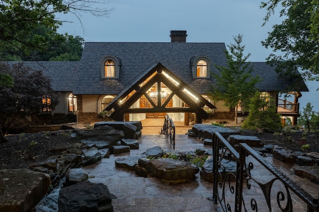 view of front of home with a patio area and a chimney