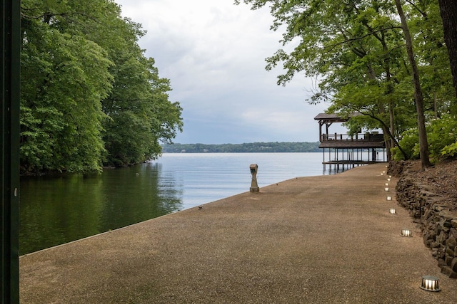 view of dock with a gazebo and a water view