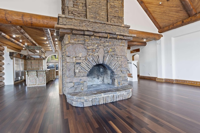 interior space with wood finished floors, wood ceiling, arched walkways, and beam ceiling