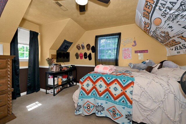  - bedroom with lofted ceiling, carpet flooring, a textured ceiling, and ceiling fan