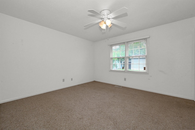  - empty room featuring carpet, ceiling fan, and baseboards