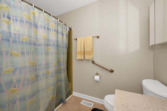  - bathroom with toilet, baseboards, and tile patterned floors