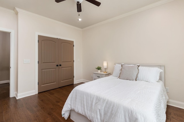 bedroom with dark wood finished floors, baseboards, and ornamental molding