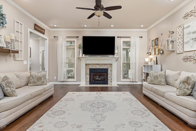 living room with a tiled fireplace, dark wood-type flooring, recessed lighting, and crown molding