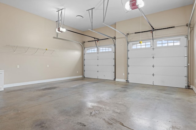 garage with a garage door opener and baseboards