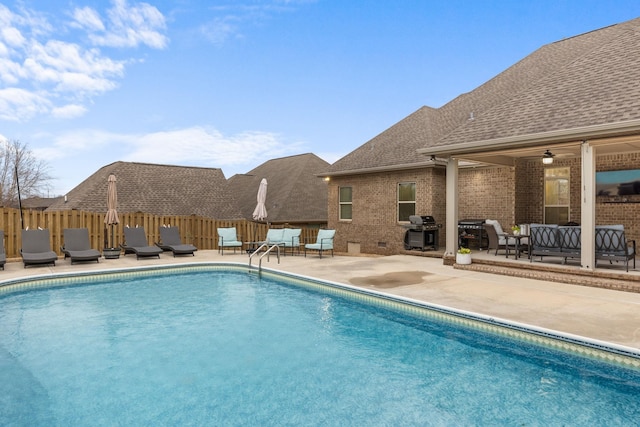 view of swimming pool with an outdoor living space, fence, a grill, a fenced in pool, and a patio area