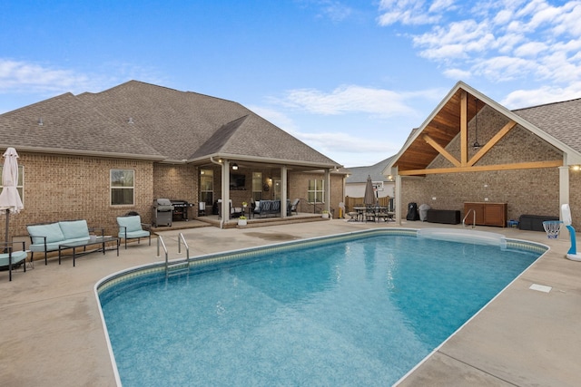 view of swimming pool featuring an outdoor living space, a grill, a fenced in pool, and a patio