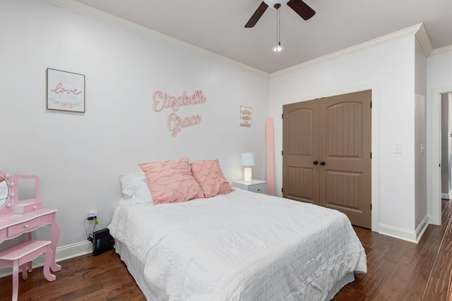 bedroom featuring a closet, baseboards, ornamental molding, and dark wood-style flooring