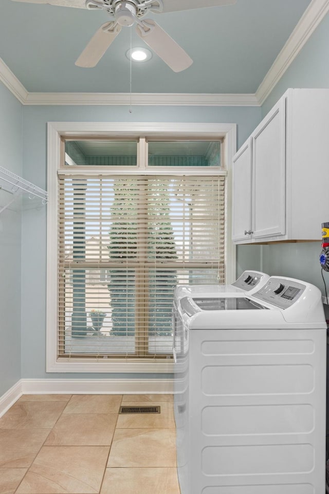 washroom with washing machine and dryer, cabinet space, crown molding, and visible vents