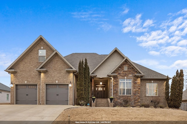 craftsman inspired home featuring concrete driveway, a garage, brick siding, and roof with shingles