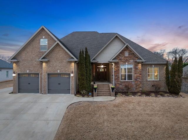 craftsman-style house featuring concrete driveway, a garage, brick siding, and a shingled roof