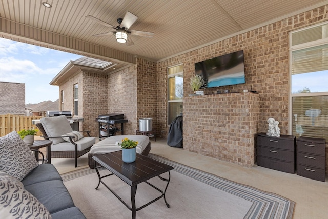 view of patio featuring grilling area, a ceiling fan, outdoor lounge area, and fence