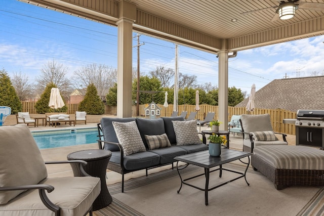 view of patio with area for grilling, an outdoor hangout area, a ceiling fan, and a fenced backyard