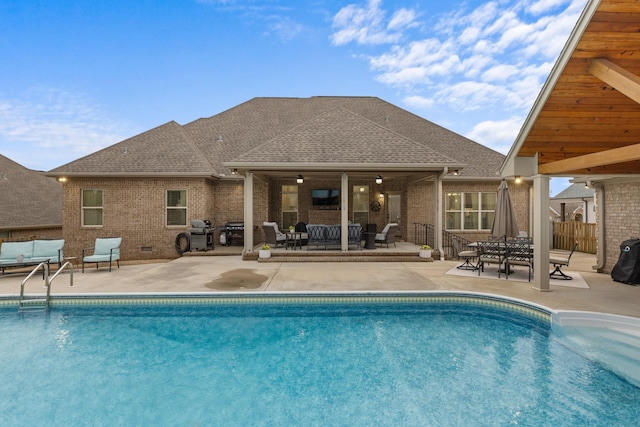 view of pool with fence, a grill, a fenced in pool, an outdoor hangout area, and a patio area