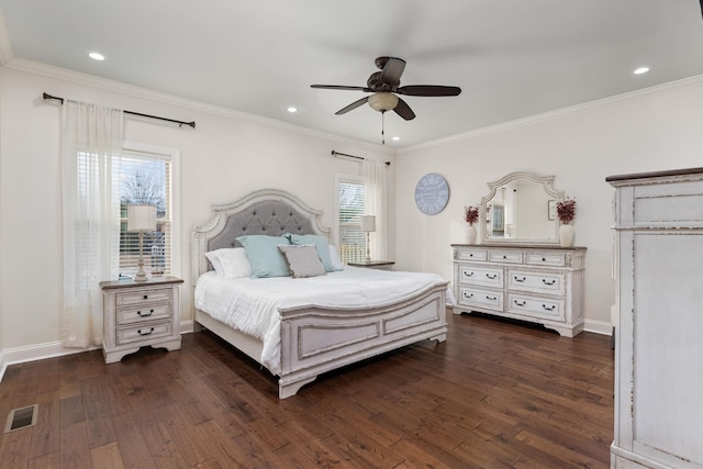 bedroom with visible vents, crown molding, and dark wood-style flooring