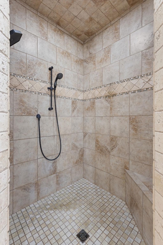 bathroom with a tile shower