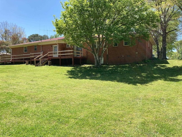 view of yard with a wooden deck and stairs